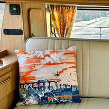 Load image into Gallery viewer, Camper van interior with a sofa and decorative cushion featuring orange and blue graphic design