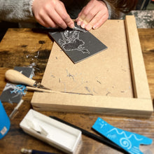 Load image into Gallery viewer, A linocut student carves a rose and bird designed and taught by Fabia
