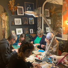 Load image into Gallery viewer, 5 students are carving and working on their bespoke linocut designs